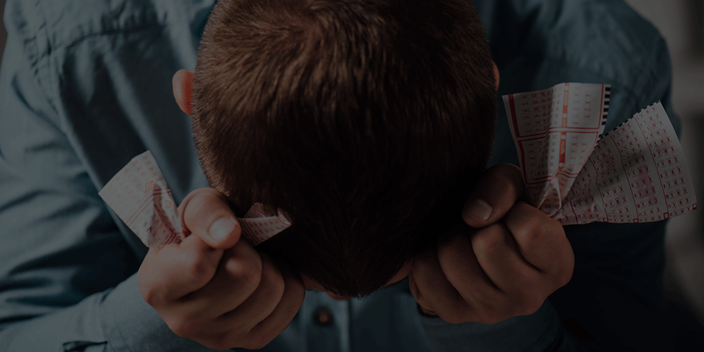 man holding lottery tickets